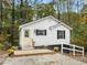 Charming house featuring a white exterior, black shutters and a welcoming front porch at 5485 Mercedes Dr, Cumming, GA 30041