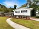 Brick ranch house with a landscaped yard and walkway at 2390 Sandgate Rd, Atlanta, GA 30349
