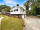 Ranch house with a well-maintained lawn, attached garage, and brick driveway at 2390 Sandgate Rd, Atlanta, GA 30349