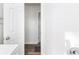 Bathroom with white subway tile and access to a hallway at 1246 Lyle Ave, East Point, GA 30344