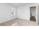 Bright bedroom with neutral carpeting and access to the kitchen at 1246 Lyle Ave, East Point, GA 30344