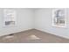 Well-lit bedroom with neutral carpeting and two large windows at 1246 Lyle Ave, East Point, GA 30344