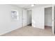 Bright bedroom with neutral carpeting, ample closet space, and access to a hallway bathroom at 1246 Lyle Ave, East Point, GA 30344