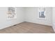 Spacious bedroom with neutral carpeting and two windows at 1246 Lyle Ave, East Point, GA 30344