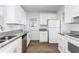 Bright eat-in kitchen with white cabinets, granite countertops, and stainless steel appliances at 1246 Lyle Ave, East Point, GA 30344
