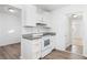 Modern kitchen with white cabinets, granite countertops, and stainless steel appliances at 1246 Lyle Ave, East Point, GA 30344