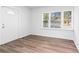 Bright and airy living room with new wood-look flooring and large windows at 1246 Lyle Ave, East Point, GA 30344
