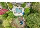 Aerial view of house, pool, and surrounding landscape at 879 Big Horn Hollow, Suwanee, GA 30024