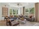 Spacious living room featuring gray sectional sofa, wooden coffee table, and large windows at 1090 Battery Park Rd, Decatur, GA 30033