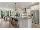 Modern kitchen with white cabinets, large island, and stainless steel appliances at 1090 Battery Park Rd, Decatur, GA 30033