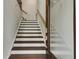 Modern staircase with dark brown wood and white risers at 1090 Battery Park Rd, Decatur, GA 30033