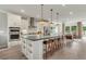 Modern kitchen with white cabinets, large island, and stainless steel appliances at 1090 Battery Park Rd, Decatur, GA 30033