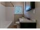 Clean bathroom with white tile, a tub, and dark vanity at 1784 Danrich Dr, Decatur, GA 30032