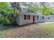 Brick ranch house with red front door, landscaping, and large trees at 1784 Danrich Dr, Decatur, GA 30032