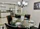 Bright dining area with a glass table, four chairs, and a modern chandelier at 2501 Henderson Mill Ne Rd, Atlanta, GA 30345