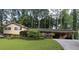 Ranch style home with brick facade, carport, and well-maintained lawn at 2501 Henderson Mill Ne Rd, Atlanta, GA 30345