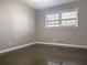 Simple bedroom with hardwood floors and large window at 2501 Henderson Mill Ne Rd, Atlanta, GA 30345