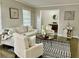 Living room features a neutral color palette, comfortable seating, and hardwood floors at 2501 Henderson Mill Ne Rd, Atlanta, GA 30345