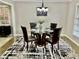 Charming dining room with a glass-top table, four chairs, and a stylish chandelier at 2501 Henderson Mill Ne Rd, Atlanta, GA 30345