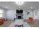 Living Room with fireplace, hardwood floors, and large TV at 1368 New Hope Rd, Lawrenceville, GA 30045