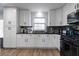 White shaker cabinets, granite countertops, and stainless steel appliances at 1368 New Hope Rd, Lawrenceville, GA 30045
