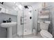 Clean bathroom with a walk-in shower, pedestal sink, and modern fixtures at 1368 New Hope Rd, Lawrenceville, GA 30045