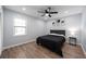 Bright bedroom featuring a queen bed, ceiling fan and hardwood floors at 1368 New Hope Rd, Lawrenceville, GA 30045