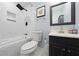 Updated bathroom with a tub and dark vanity at 1368 New Hope Rd, Lawrenceville, GA 30045