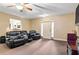 Living room with black leather recliners, a ceiling fan, and a door leading outside at 156 Westin Park Dr, Locust Grove, GA 30248