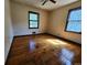 Well-lit bedroom featuring hardwood floors and two windows at 25 Bryans Dr, Mcdonough, GA 30252