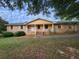 Brick ranch home with yellow accents and carport at 25 Bryans Dr, Mcdonough, GA 30252