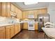 Kitchen with light wood cabinets, stainless steel appliances, and hardwood floors at 4573 Caleb Xing, Powder Springs, GA 30127