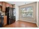 Kitchen with wood cabinets, black appliances, and hardwood floors at 3601 Kasner Nw Ct, Kennesaw, GA 30144