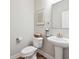 Modern powder room with pedestal sink and wood-look floors at 802 Oak Promenade Ln, Canton, GA 30115