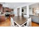Kitchen with island, dining area with table and chairs and a view into the living room at 2397 Sardis Chase Ct, Buford, GA 30519