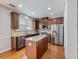 Island kitchen features granite countertops and stainless steel appliances at 2397 Sardis Chase Ct, Buford, GA 30519