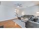 Living room with hardwood floors, sectional sofa, and view of the staircase at 2397 Sardis Chase Ct, Buford, GA 30519