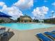 Community swimming pool with a pool house and lounge chairs at 2397 Sardis Chase Ct, Buford, GA 30519