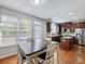 Bright kitchen dining area with table and chairs, overlooking backyard at 2397 Sardis Chase Ct, Buford, GA 30519