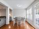 Bright dining area with hardwood floors, white table, and chairs near a door to the backyard at 2397 Sardis Chase Ct, Buford, GA 30519