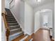 Inviting entryway with hardwood floors and staircase to upper level at 2397 Sardis Chase Ct, Buford, GA 30519