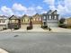 Row of townhouses with attached garages and manicured lawns at 2397 Sardis Chase Ct, Buford, GA 30519