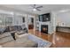 Spacious living room with hardwood floors, fireplace, and sectional sofa at 2397 Sardis Chase Ct, Buford, GA 30519