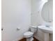 Simple bathroom with pedestal sink, toilet, and oval mirror at 2397 Sardis Chase Ct, Buford, GA 30519