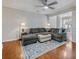 Open living area with hardwood floors, sectional sofa, and a large area rug at 2397 Sardis Chase Ct, Buford, GA 30519