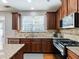 Modern kitchen with granite countertops, gas range, and stainless steel appliances at 2397 Sardis Chase Ct, Buford, GA 30519