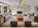 Virtually staged living room with fireplace, hardwood floors, and ample seating at 120 Birch Creek Cir, Mcdonough, GA 30253