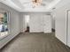 Spacious bedroom with carpet, ceiling fan, and large window at 120 Birch Creek Cir, Mcdonough, GA 30253
