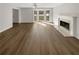 Spacious living room with hardwood floors, fireplace, and large windows at 120 Birch Creek Cir, Mcdonough, GA 30253