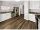 Kitchen with white cabinets, stainless steel appliances, and dark hardwood floors at 120 Birch Creek Cir, Mcdonough, GA 30253